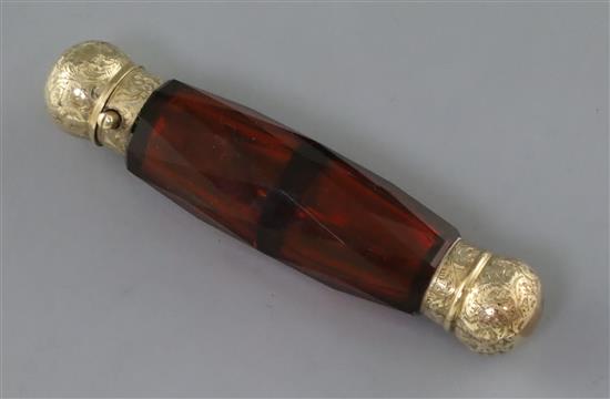 A Victorian engraved gold mounted double ended facet cut ruby glass scent bottle, 12cm.